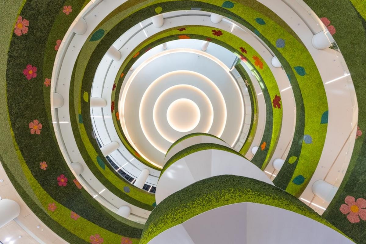 a toddler wearing a custom-designed, eco-friendly outfit with bold patterns and playful accessories